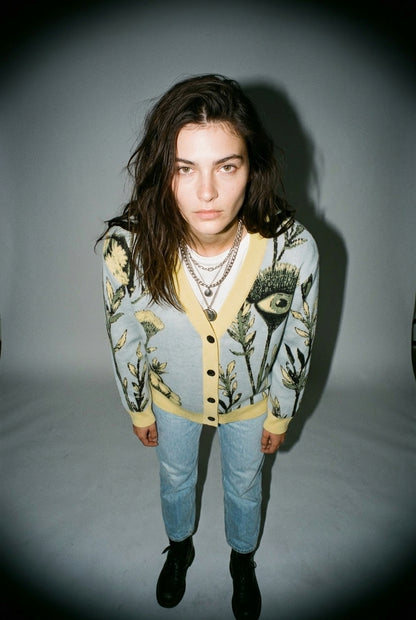 TANSY EYE light blue V-neck cardigan with yellow trim and stylized eye print