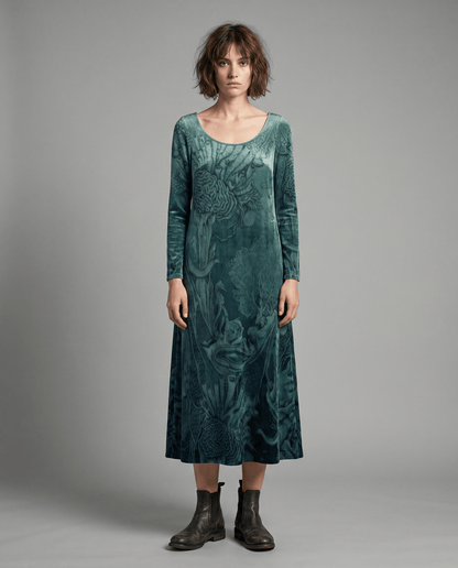 Front portrait of model in teal velvet dress with embedded sea creature design