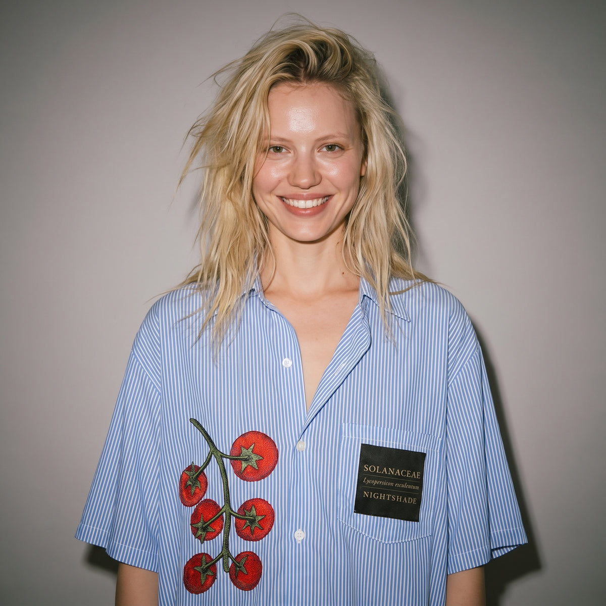 Model wearing relaxed fit Riffhaus blue pinstripe shirt with tomato vine detail