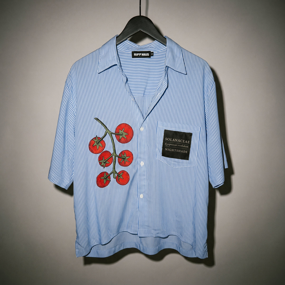 Riffhaus light blue pinstripe shirt on hanger showing casual drape and embroidery