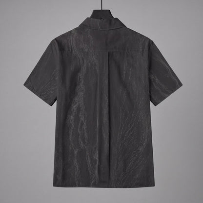 Back view of dark gray slub cotton short sleeve button up shirt on hanger