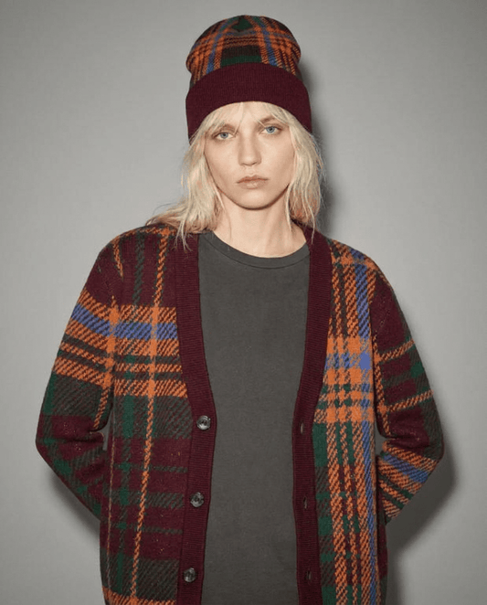 Model wearing multi-colored plaid cardigan and matching beanie hat